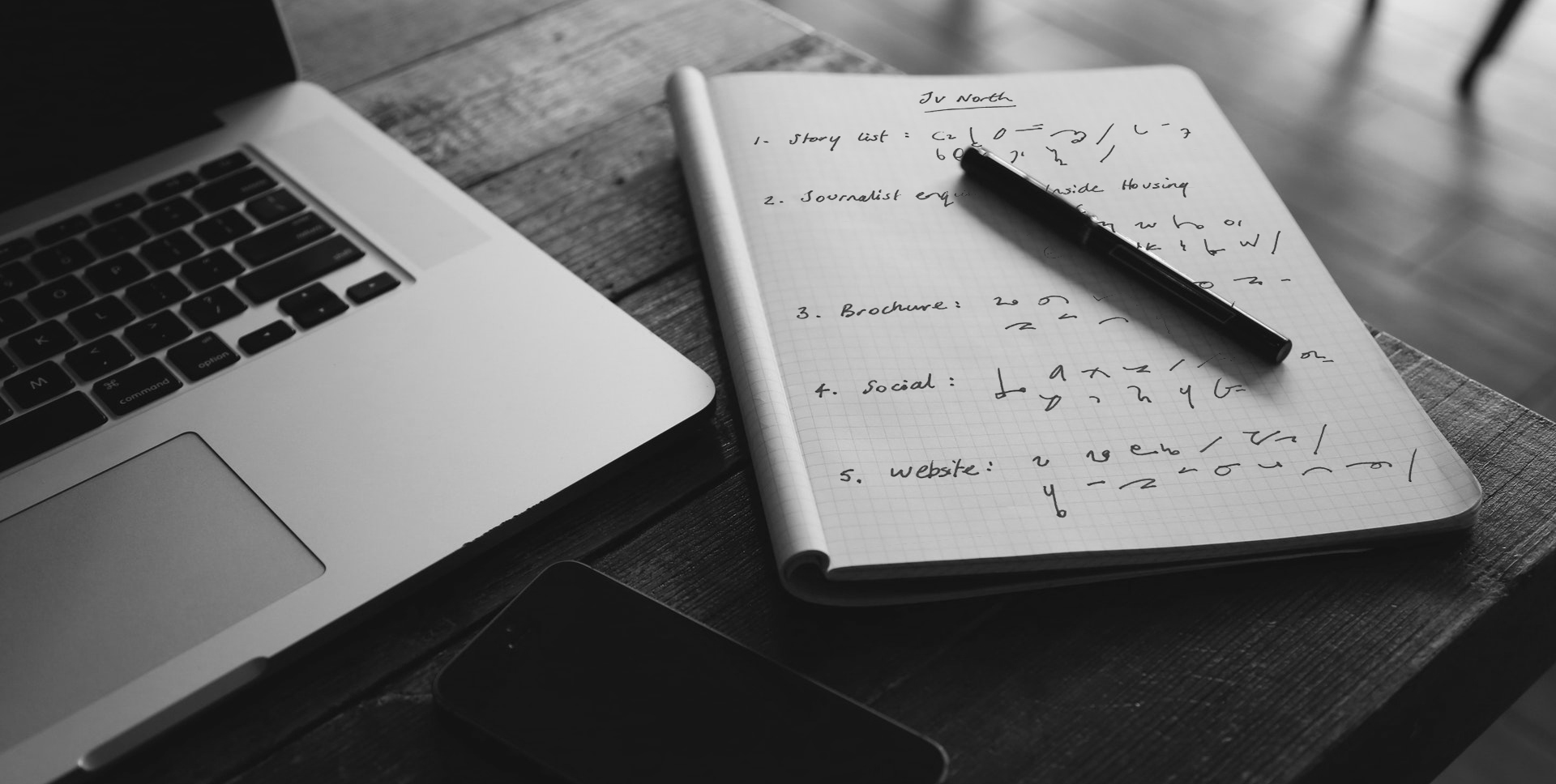 Laptop and notepad with shorthand